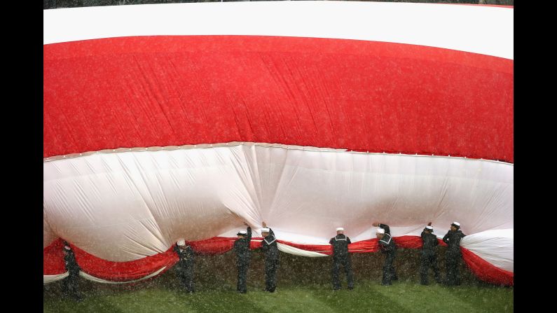 U.S. sailors try to corral a large American flag before the home opener of the Chicago White Sox on Friday, April 8. <a href="index.php?page=&url=http%3A%2F%2Fwww.cnn.com%2F2016%2F04%2F05%2Fsport%2Fgallery%2Fwhat-a-shot-sports-0405%2Findex.html" target="_blank">See 29 amazing sports photos from last week</a>