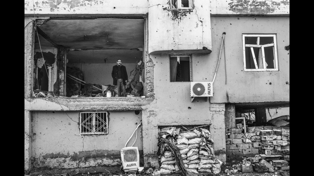 A man stands in his damaged home in Silopi, Turkey, in January.