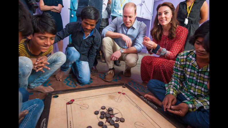 William and Catherine play a game with children at a New Delhi railway station on April 12.