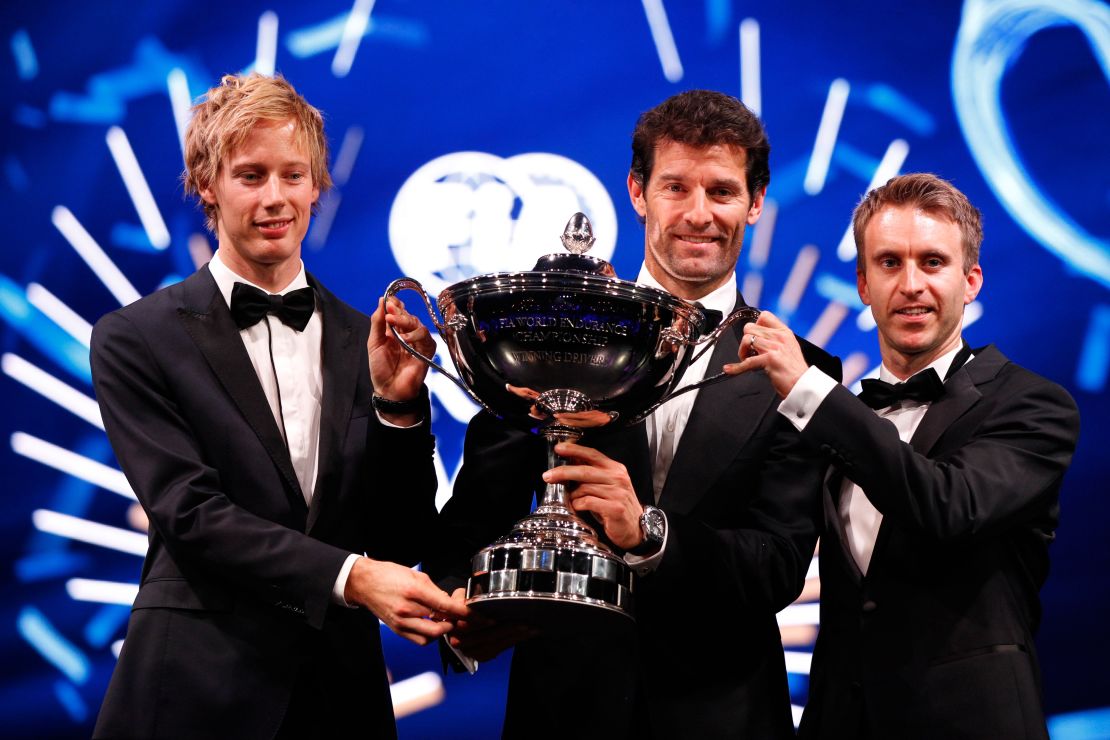 Three's the magic number: Mark Webber (center) and Porsche teammates Brendon Hartley (left)and Timo Bernhard (right) collect their WEC prize.