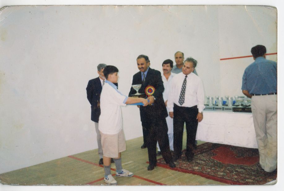 Receiving her first squash trophy. She won the under-13 category at the 2002 Hashim Khan Junior Squash Championship.