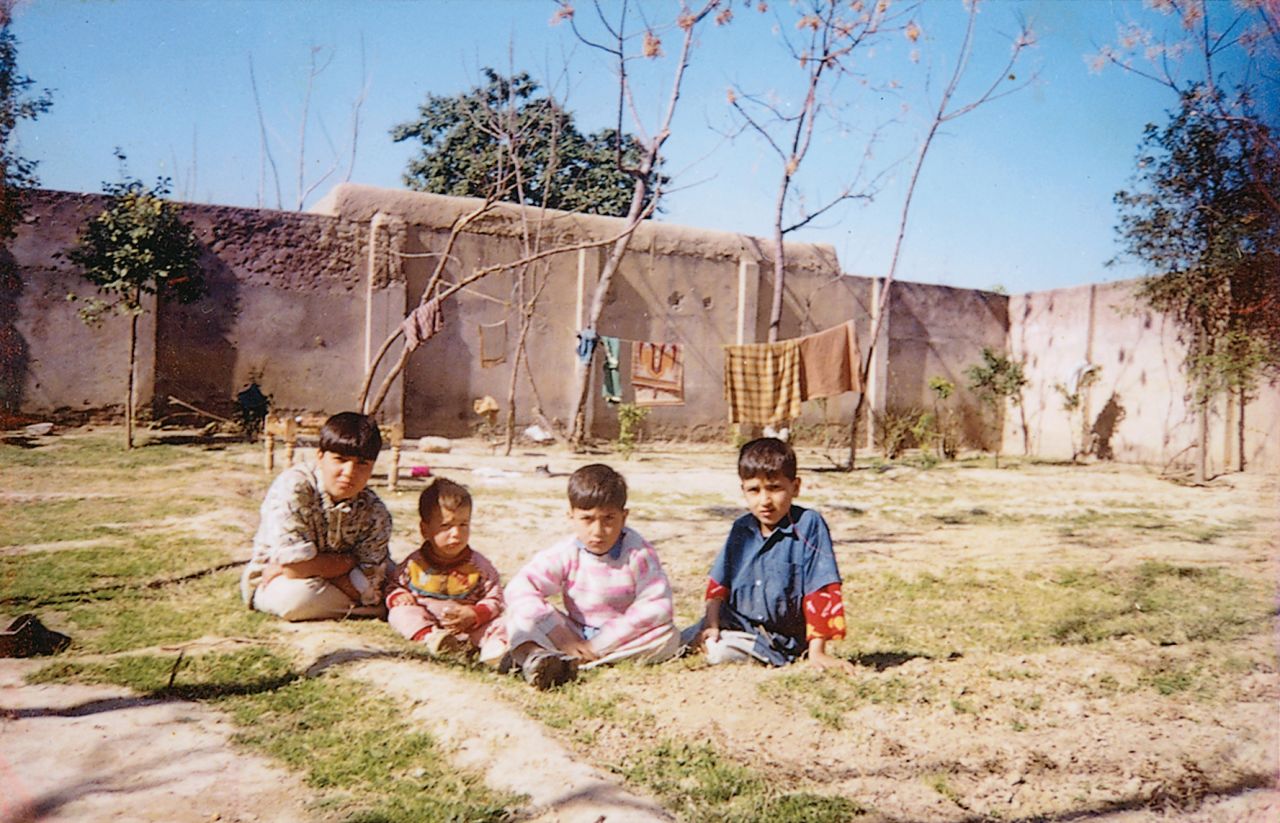 Sitting in the dirt in Darra Adam Khel. Maria is the "boy" on the far left -- she called herself "Changez Khan" to compete as a male in weightlifting.