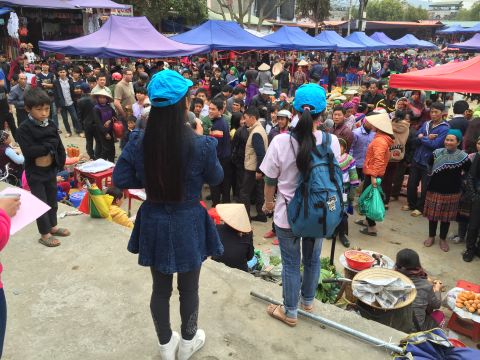 Two girls who have escaped trafficking and returned to Vietnam share their personal experiences to warn others at a market in Northern Vietnam. 