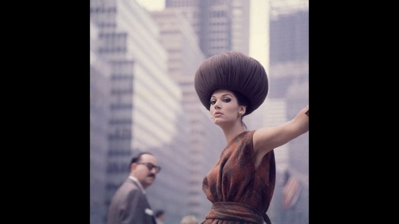 A model wears a bulbous hat and a plaid, boatneck dress as she stands on a city street in 1962. Conde Nast teamed up with Getty Images to release the archival photos. "We'd been after their content for some time. It's beautiful," said Bob Ahern, Getty's archive director. "Fashion is cyclical, it draws so readily on inspiration of the past. To have these images available is amazing."
