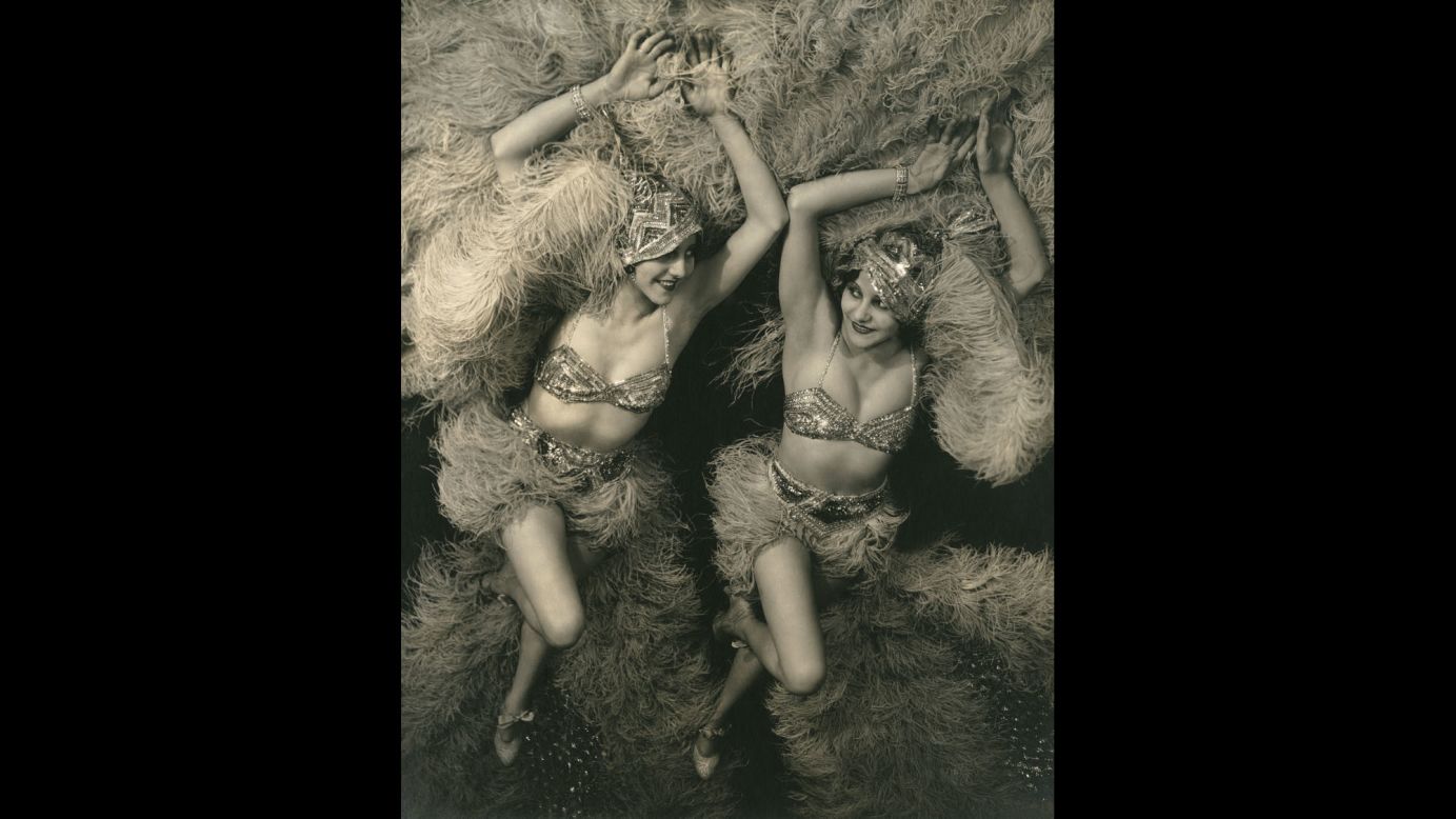 Actresses Beth and Betty Dodge wear matching stage costumes as they take a publicity portrait in 1929. The twins wore sequined caps, tops and bloomers to go with ostrich-feather skirts and fans. 