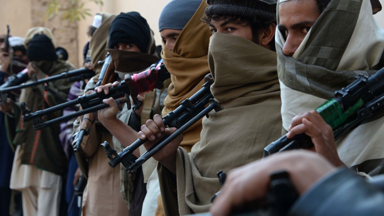 Former Taliban fighters hold weapons they plan to return in a 2015 reconciliation event in Jalalabad, Afghanistan.