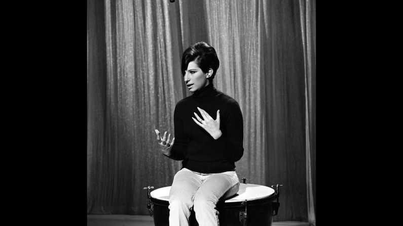 Streisand sits on a kettledrum during a rehearsal.