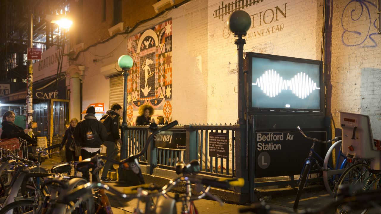 Pedestrians enter a subway station in the hip  and bicycle-heavy neighborhood of Williamsburg.