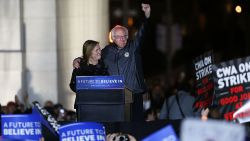 Bernie Sanders stands on stage with his wife Jane O'Meara Sanders before speaking to thousands of people at a rally for in New York City's historic Washington Square Park on April 13, 2016 in New York City.