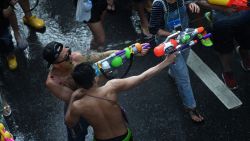 People take part in water battles as they celebrate Songkran - the Thai new year - in Bangkok on April 13, 2016.
Thais and tourists took to the streets on April 13 to drench each other in the mass water fight that marks the country's new year festival Songkran, as authorities attempted to crack down on alcohol, topless dancers and other "indecencies".