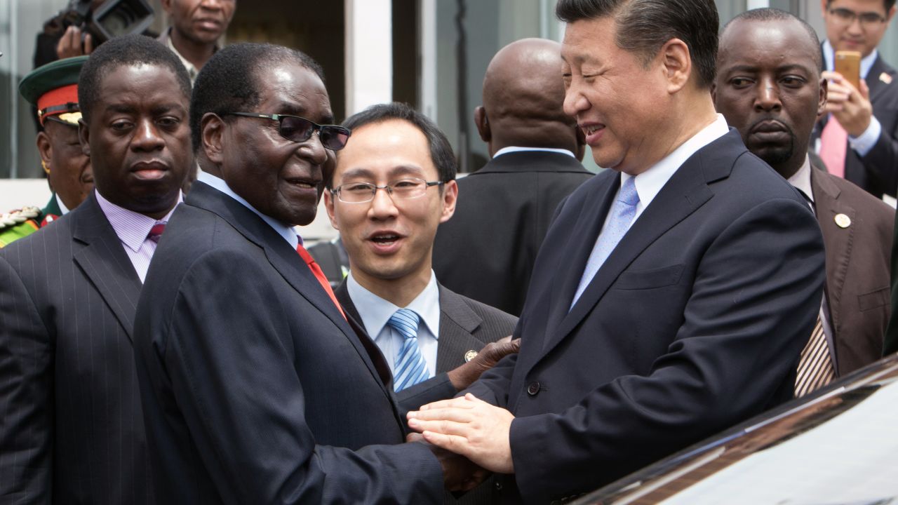China's President Xi Jinping shakes  hands  with Zimbabwe's President Robert Mugabe in Harare 