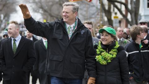 Gov. Charlie Baker of Massachusetts and wife Lauren Baker march in the annual South Boston St. Patrick's Parade passes on March 20, 2016.