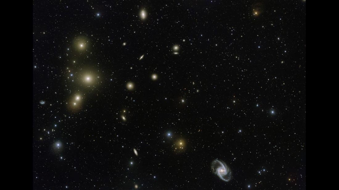 This image from the VLT Survey Telescope at ESO's Paranal Observatory in Chile shows a stunning concentration of galaxies known as the Fornax Cluster, which can be found in the Southern Hemisphere. At the center of this cluster, in the middle of the three bright blobs on the left side of the image, lies a cD galaxy -- a galactic cannibal that has grown in size by consuming smaller galaxies.