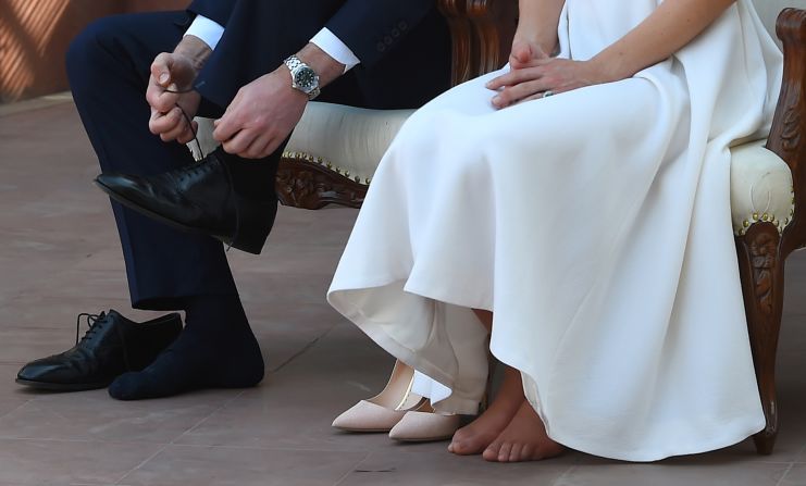The couple removes their shoes as they pay respect at Gandhi Smriti on April 11. The house is where Mahatma Gandhi, India's founding father, spent the last few years of his life.
