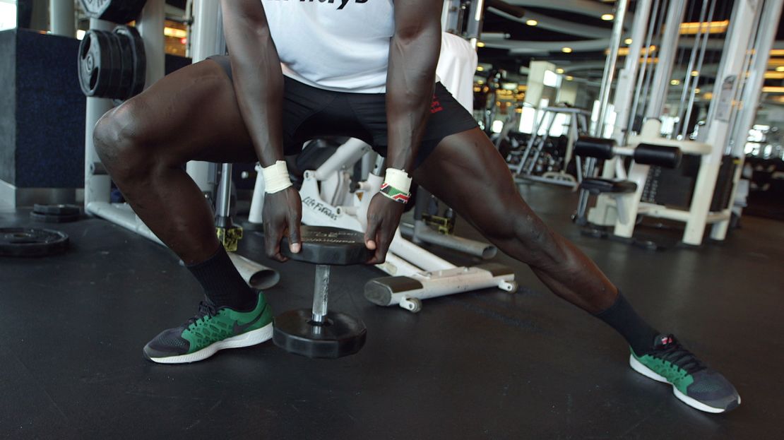 Holding the weight, Injera lunges to the right and then back across to the left.