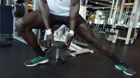 Holding the weight, Injera lunges to the right and then back across to the left.