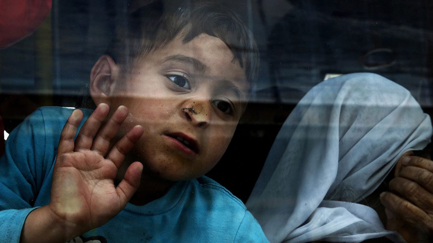 A boy looks out of a bus window as migrants from Syria and Iraq are transferred to a facility in Skaramagas, Greece, on Monday, April 11. <a href="http://www.cnn.com/2015/09/03/world/gallery/europes-refugee-crisis/index.html" target="_blank">See Europe's migration crisis in 25 photos</a>