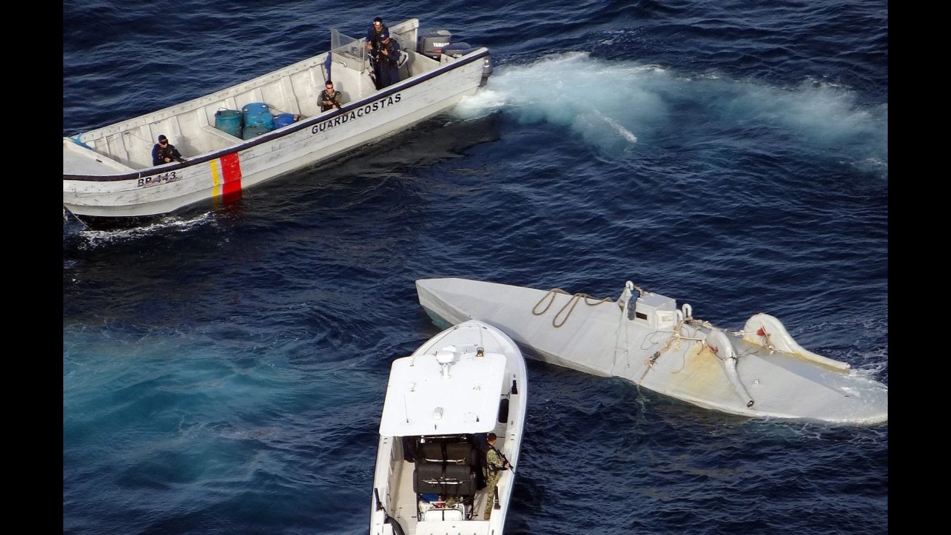 The Colombian Navy intercepts a submersible, right, that was carrying 6 tons of cocaine between Colombia and Ecuador on Wednesday, April 13.