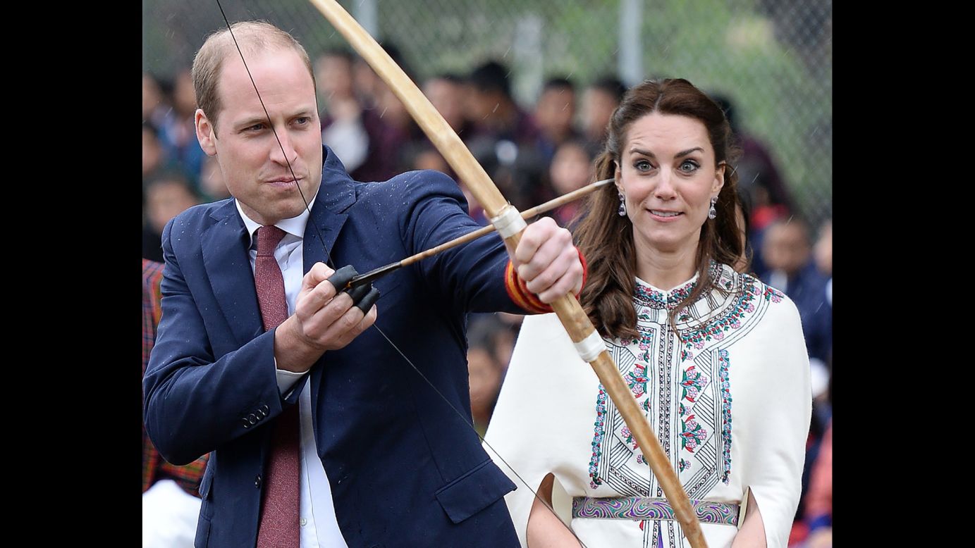 Britain's Prince William fires an arrow as his wife Catherine, the Duchess of Cambridge, watches in Paro, Bhutan, on Thursday, April 14. She also got to take part in the archery demonstration. <a href="http://www.cnn.com/2016/04/10/asia/gallery/royals-visit-india/index.html" target="_blank">See more photos of the royal couple's trip to Bhutan and India</a>