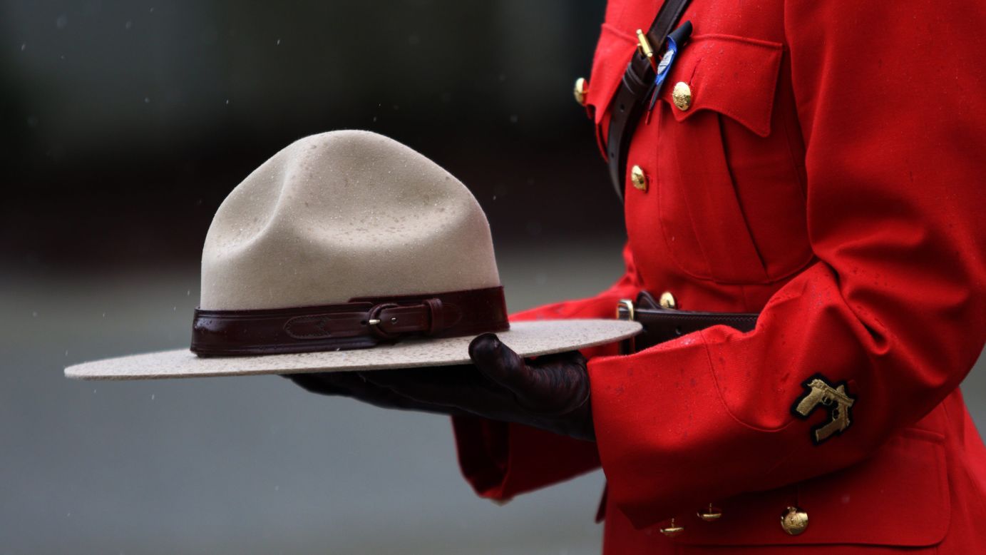 An officer with the Royal Canadian Mounted Police holds a hat during a funeral service for Const. Sarah Beckett on Tuesday, April 12. Beckett was killed when a pickup truck collided with her cruiser. She was 32.