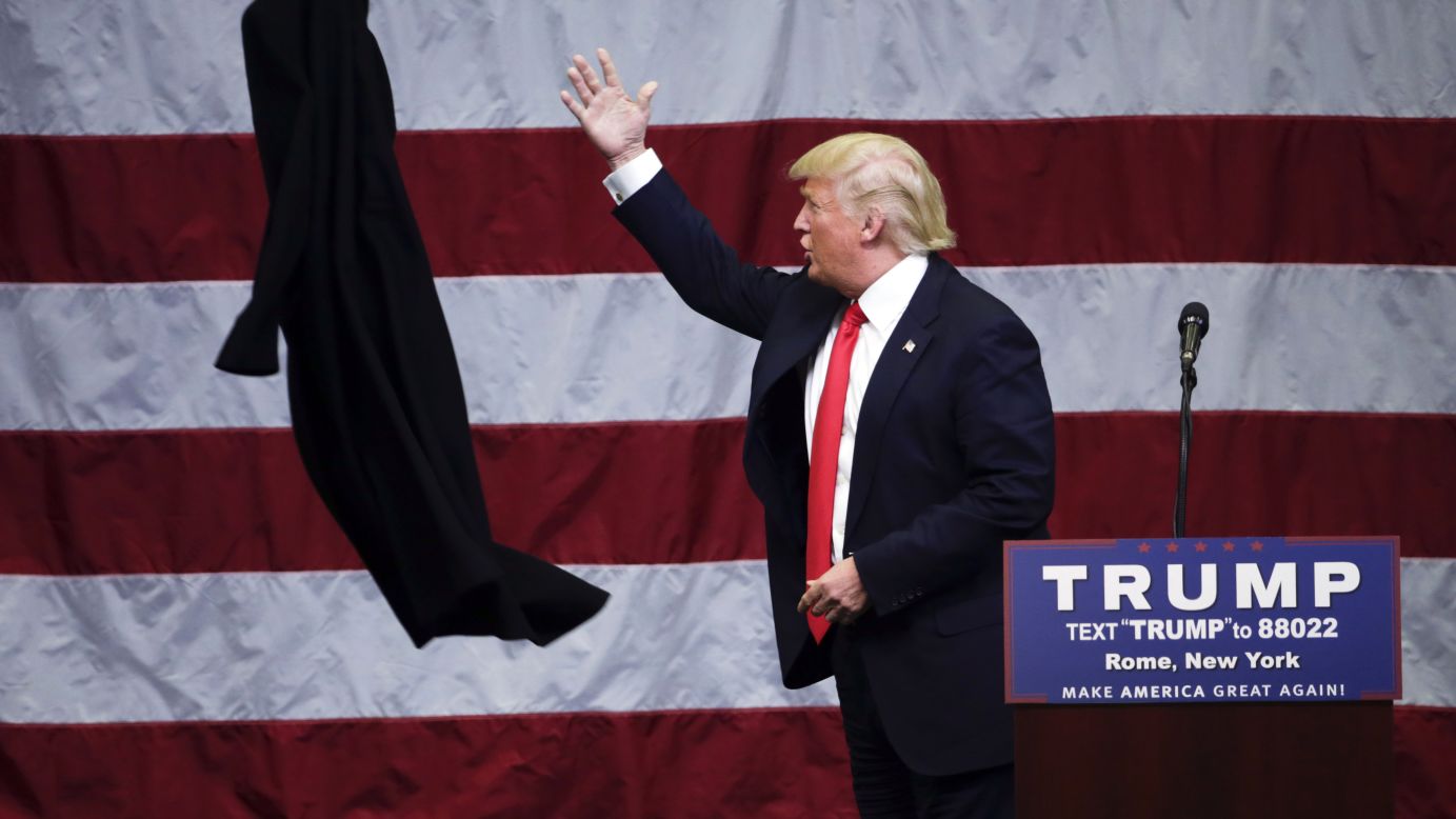 Republican presidential candidate Donald Trump tosses his coat during a rally in Rome, New York, on Tuesday, April 12.