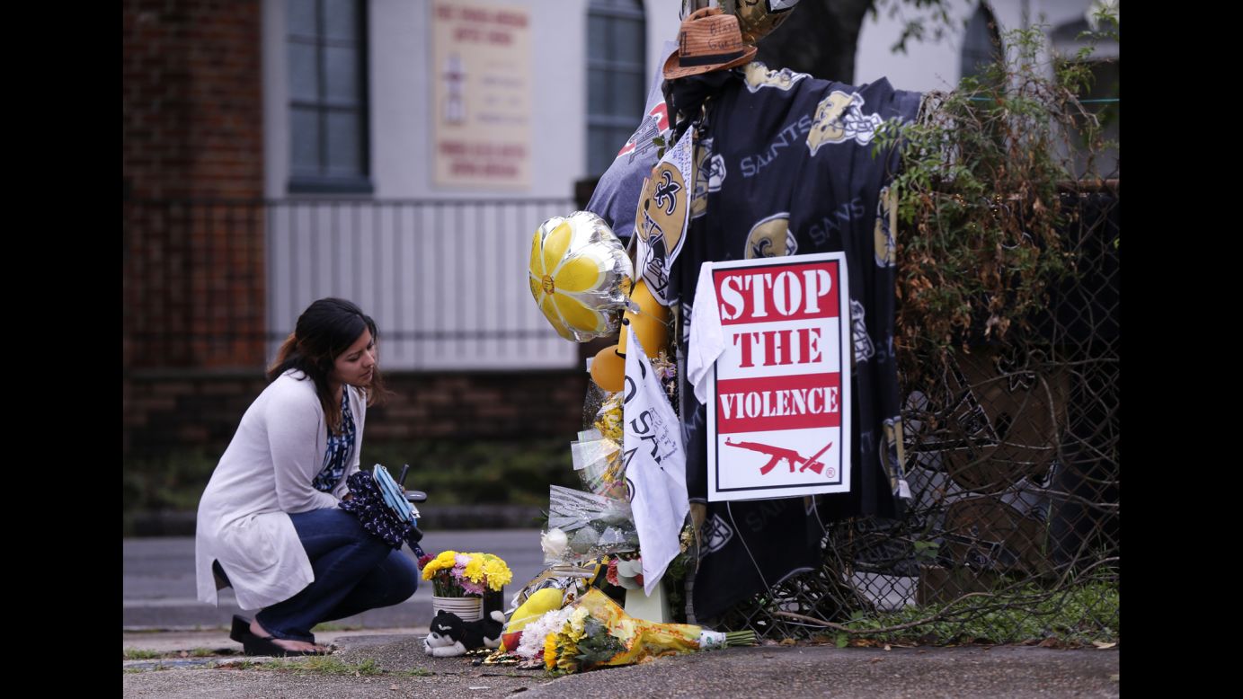 A woman pauses at a makeshift memorial near the spot where former pro football player Will Smith <a href="http://www.cnn.com/2016/04/14/us/will-smith-former-new-orleans-saints-player-killed/" target="_blank">was fatally shot</a> in New Orleans on Saturday, April 9. He was 34.