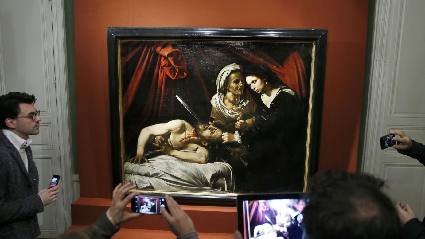 People in Paris take photos of "Judith Beheading Holofernes," a 400-year-old painting, on Tuesday, April 12. The painting, which is thought to be the work of Italian master Caravaggio, <a href="http://www.cnn.com/2016/04/13/europe/treasured-french-painting-recovered/index.html" target="_blank">was found by accident</a> in a house attic. Experts value it at around 120 million euros ($136 million).