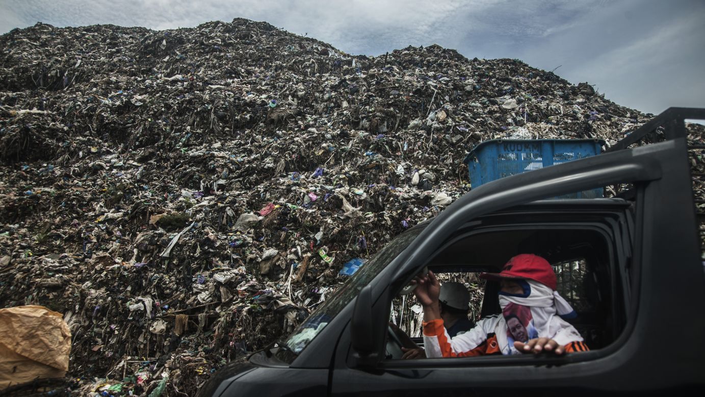 A scavenger picks up trash from the overloaded Degayu Landfills in Pekalongan, Indonesia, on Thursday, April 14.