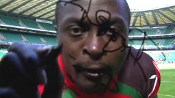 Collins Injera signs a TV camera after scoring his 200th sevens try, against Japan in 2015.