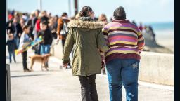 A woman helps an overweight person on April 12, 2016 in Berck-sur-Mer, northern France. / AFP / PHILIPPE HUGUEN        (Photo credit should read PHILIPPE HUGUEN/AFP/Getty Images)