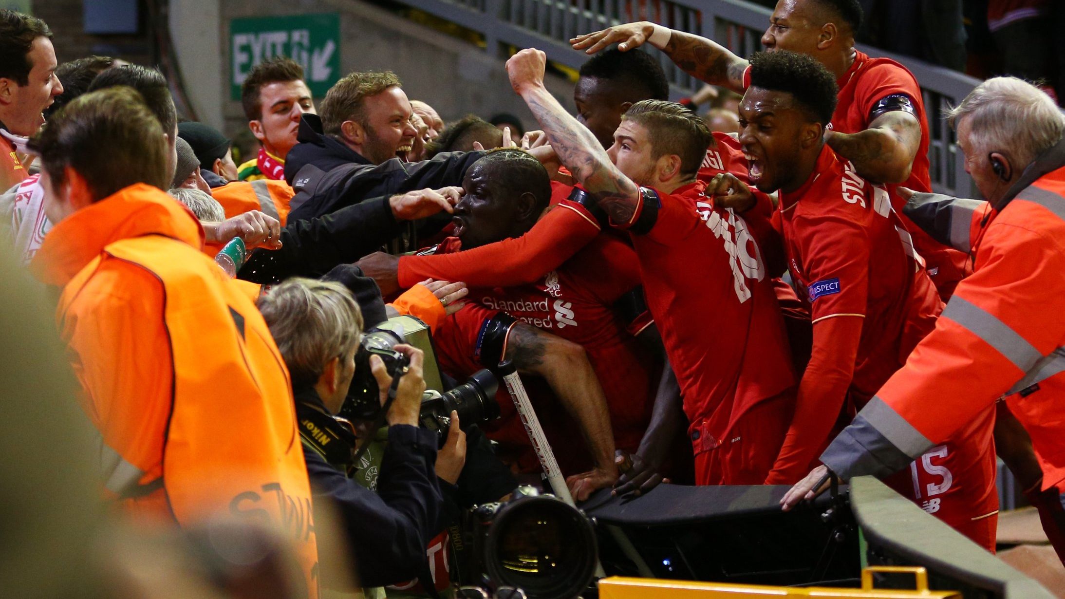 Liverpool players and fans mob Dejan Lovren after his crucial goal.