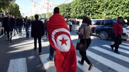 TOPSHOT - A Tunisian man wears a cloth with a print of his national flag during a rally on January 14, 2016 in the Habib Bourguiba Avenue in the capital Tunis to mark the fifth anniversary of the 2011 revolution.
Thousands gathered in the Tunisian capital to mark the fifth anniversary of the overthrow of longtime dictator Zine El Abidine Ben Ali in the uprising that inspired the Arab Spring.

 / AFP / FETHI BELAID        (Photo credit should read FETHI BELAID/AFP/Getty Images)