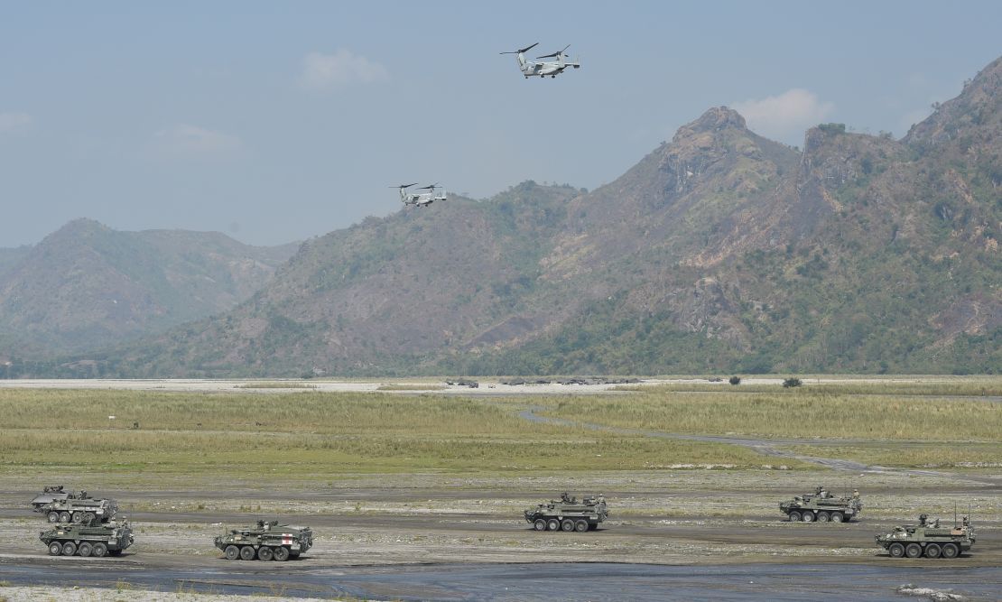 Two V-22 Osprey aircraft hover above armored personnel carriers of the Philippine army and U.S. marines during the drills.