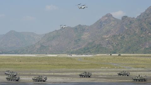 Two V-22 Osprey aircraft hover above armored personnel carriers of the Philippine army and U.S. marines during the drills.