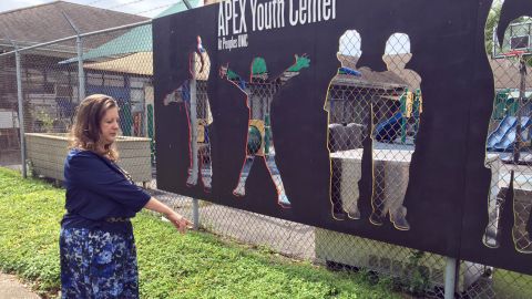 Lisa Fitzpatrick points to where a young man collapsed in front of APEX Youth Center last month.
