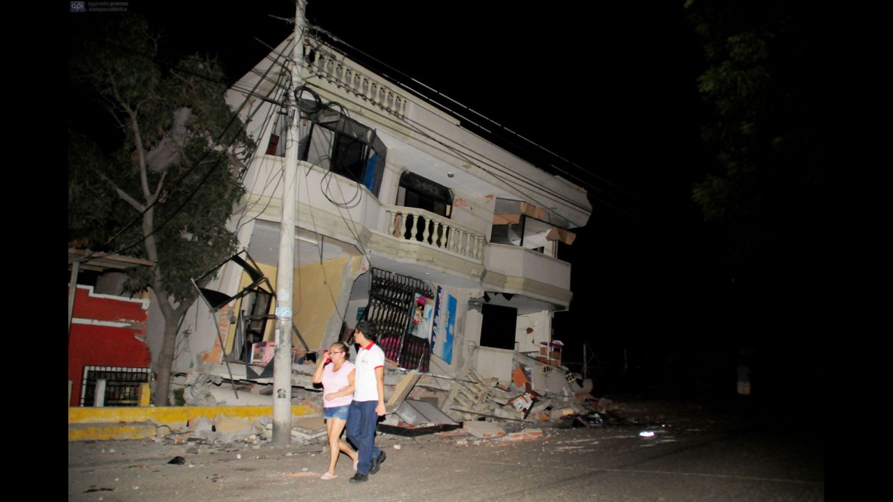 Residents walk on a street amid destroyed buildings in Guayaquil on April 16.
