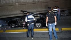 Police look at a car crushed under a collapsed overpass in Guayaquil, Ecuador, Saturday April 16, 2016. The strongest earthquake to hit Ecuador in decades flattened buildings and buckled highways along the country's coast, killing at least 41 people and causing damage hundreds of miles (kilometers) away from the epicenter in the capital and other major cities.(AP Photo/Jeff Castro)