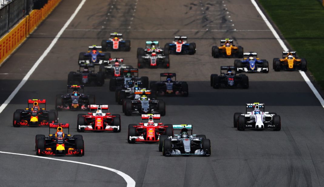 Daniel Ricciardo of Australia driving the (3) Red Bull Racing F1 car battles for position with Nico Rosberg of Germany driving the (6) Mercedes AMG Petronas F1 car at the start of the Formula One Grand Prix of China at Shanghai International Circuit on April 17, 2016 in Shanghai, China. 