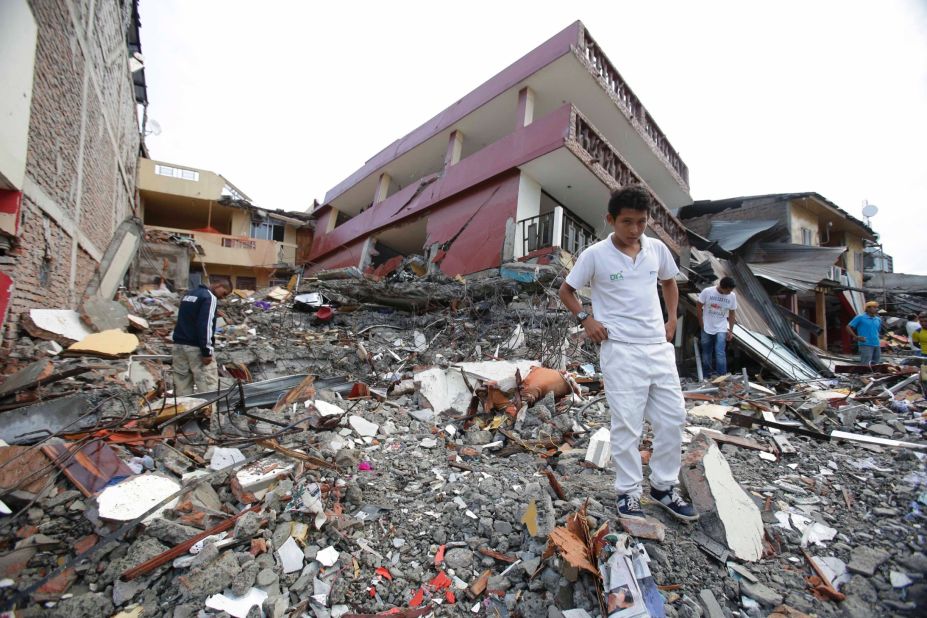 People search through the rubble of destroyed homes in Pedernales on April 17.