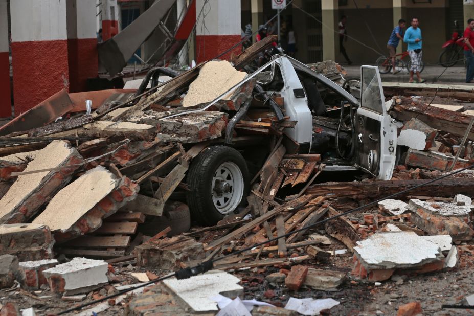 A destroyed vehicle lies under debris in Portoviejo on April 17.