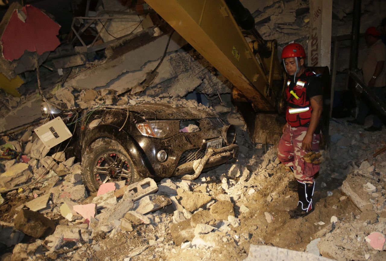 A rescue worker searches a destroyed house in Pedernales on April 17.