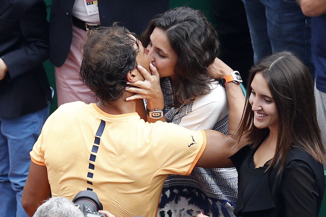 Sealed with a kiss: Nadal embraces his girlfriend Xisca Perello after winning in Monte CArlo for a record ninth time.