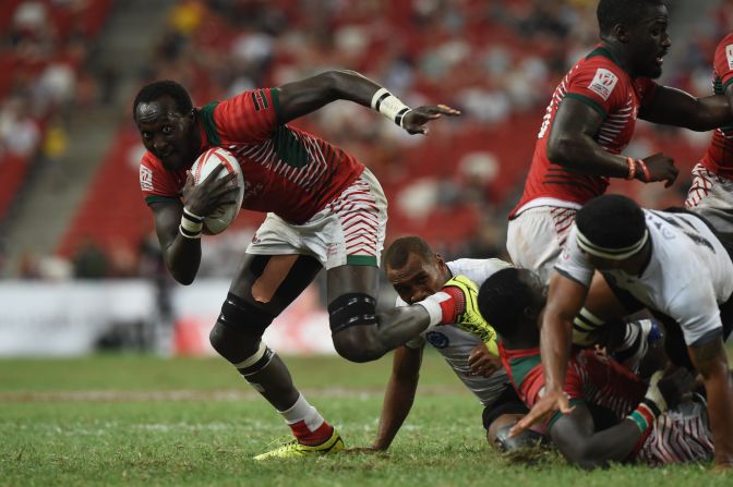 Kenya's Samuel Oliech (L) runs with ball during the cup final against Fiji at the Singapore Sevens rugby tournament on April 17, 2016.