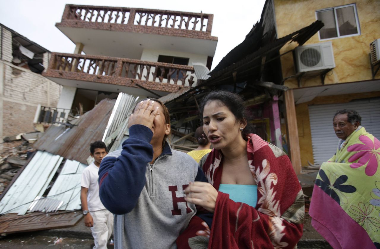 A woman cries as she stands next to a destroyed house in Pedernales, Ecuador, April 17.