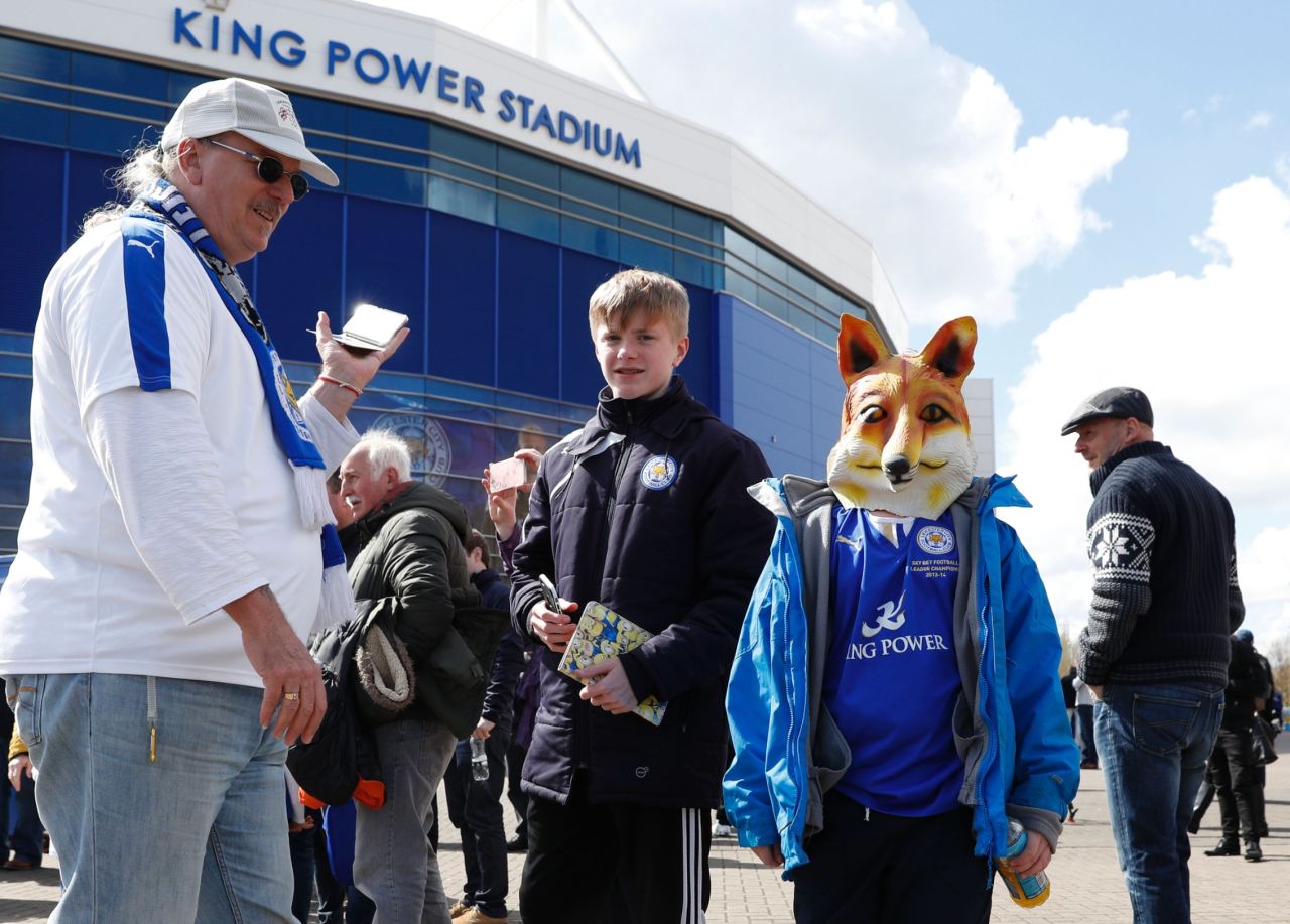 A young fan wears a fox mask outside the stadium before kick off of the English Premier League football match between Leicester City and West Ham United at King Power Stadium in Leicester.