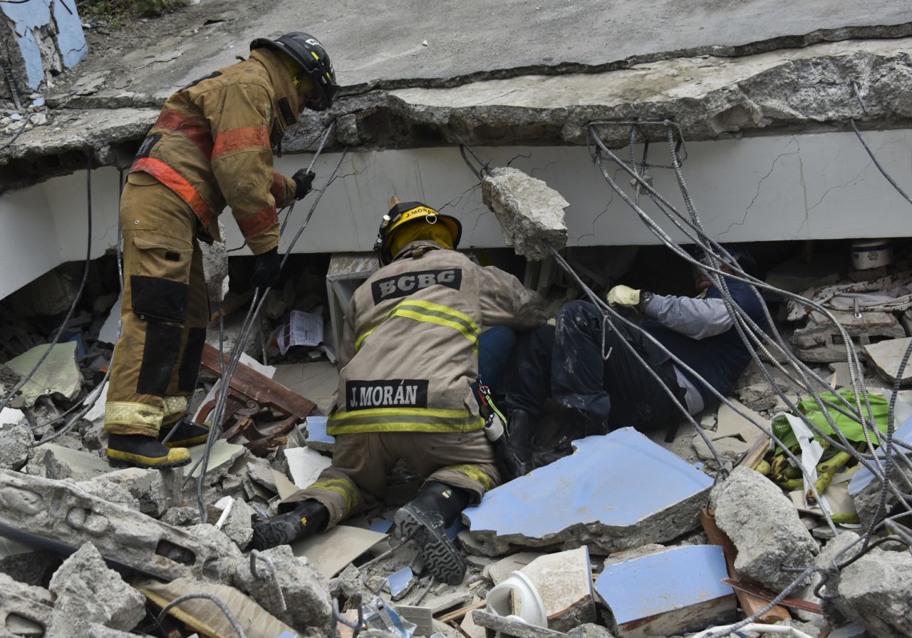 Rescue workers search the rubble of a collapsed building for victims in Guayaquil, Ecuador, on April 17.