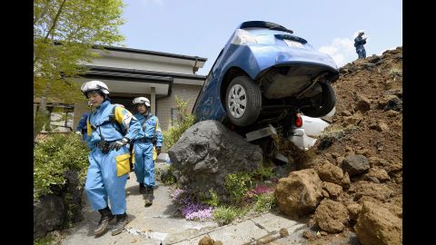 Police officers conduct a search operation at the site of a landslide caused by the quake in Minamiaso on Sunday, April 17.