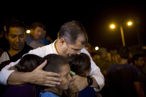 Ecuadorian President Rafael Correa kisses a group of children after meeting with local authorities at the emergency center in Portoviejo on Sunday, April 17.