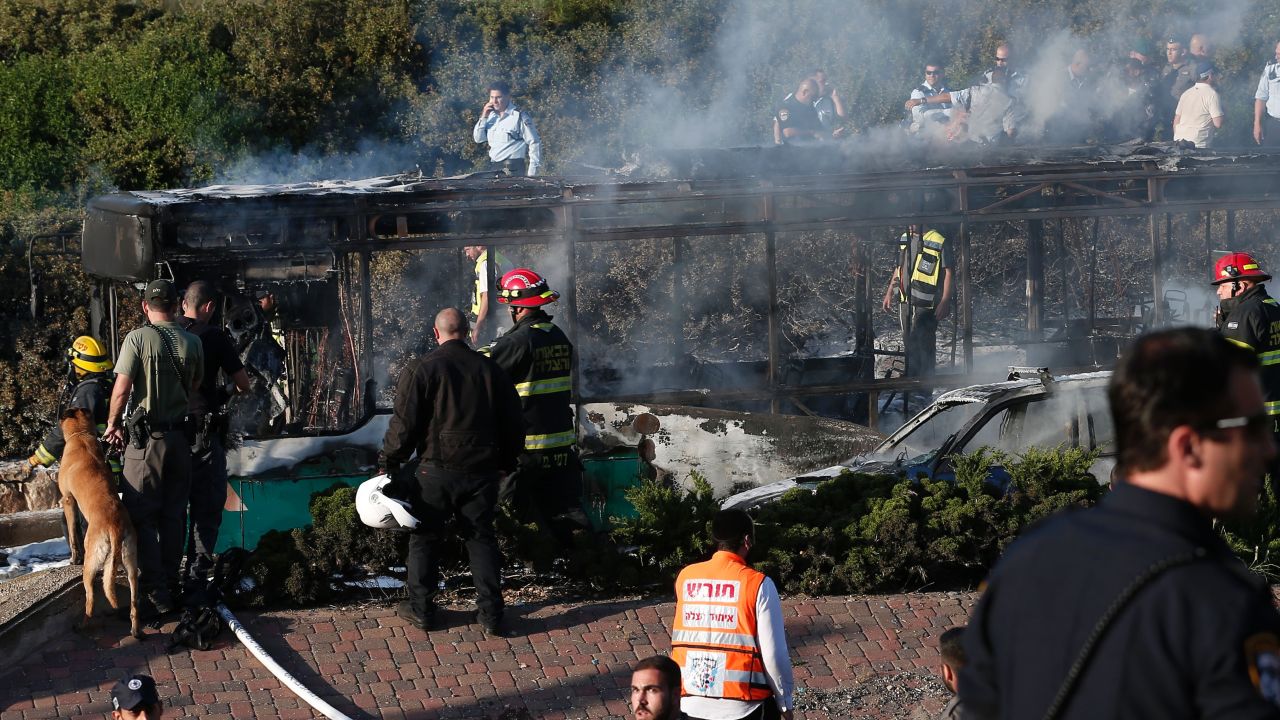 Israeli security forces and emergency services gather around a burnt-out bus following an attack in Jerusalem on April 18, 2016. Police only said there was "an attack" without providing further details. 