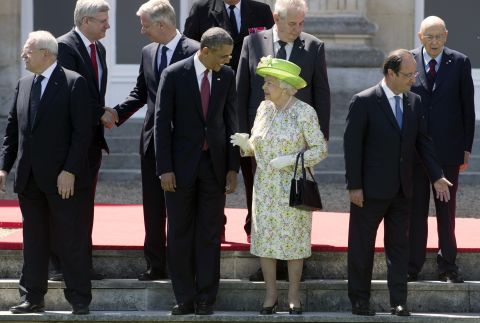 Queen Elizabeth II speaks with President Barack Obama during a group photo of world leaders attending the D-Day 70th Anniversary ceremonies at Chateau de Benouville in Benouville, France, on June 6, 2014. 
